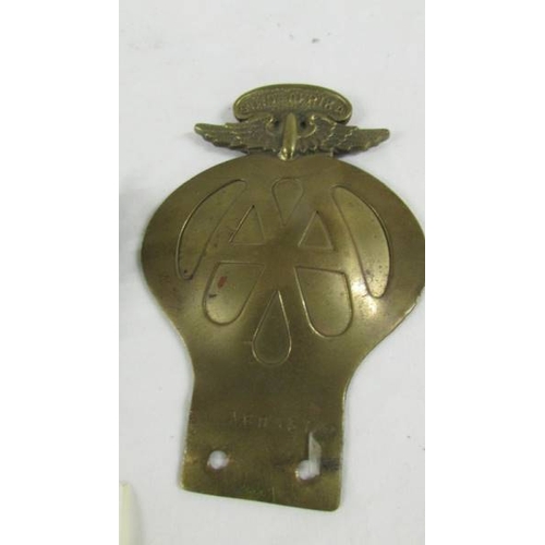 152 - A bronzed fox car mascot and a 1930's S African AA badge.