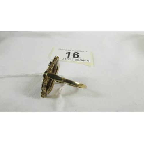 16 - A 9ct gold ring set garnets, size T.