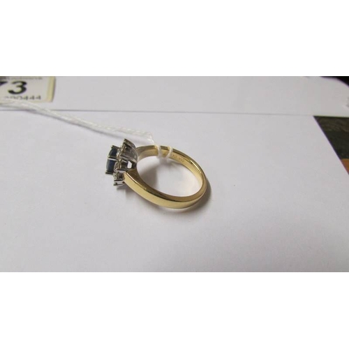 173 - An 18ct gold sapphire and diamond ring, M half.