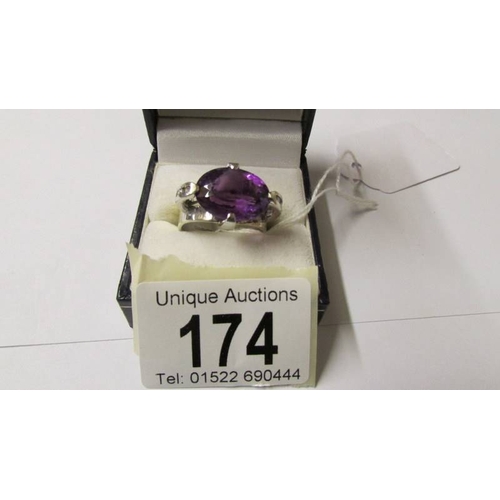 174 - A 9ct gold white gold amethyst and diamond ring, size R.