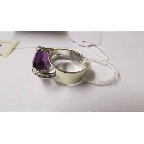 174 - A 9ct gold white gold amethyst and diamond ring, size R.