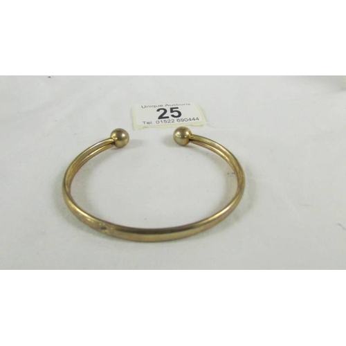 25 - A 9ct gold bangle, 9.5 grams.  (small dint).
