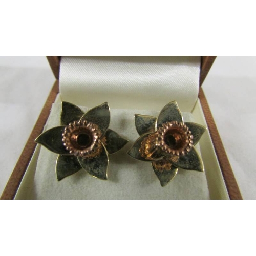 27 - A pair of 9ct gold earrings fashioned as daffodils. 4.5 grams.