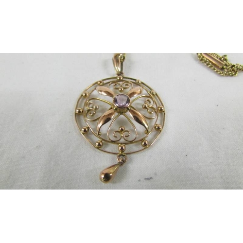 48 - An unmarked yellow metal Edwardian pendant on chains, 9.5 grams.