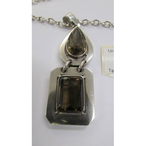 55 - A quality smoky quartz heavy silver pendant and chain with attached heart charm.  Total weight 80 gr... 