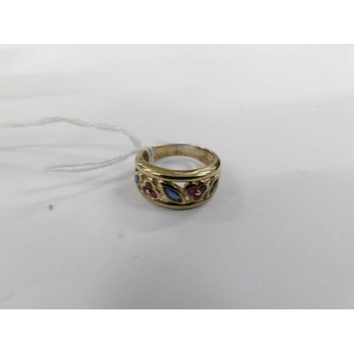 9 - A ruby and sapphire open Welsh gold work ring in a wide band in 9ct gold, size M.