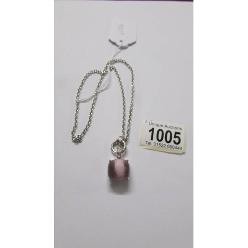 1005 - A Ti Sento Milano pendant with chain, stone set in pink, cats eye style, length approximately 40 cm.