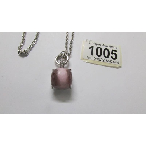 1005 - A Ti Sento Milano pendant with chain, stone set in pink, cats eye style, length approximately 40 cm.