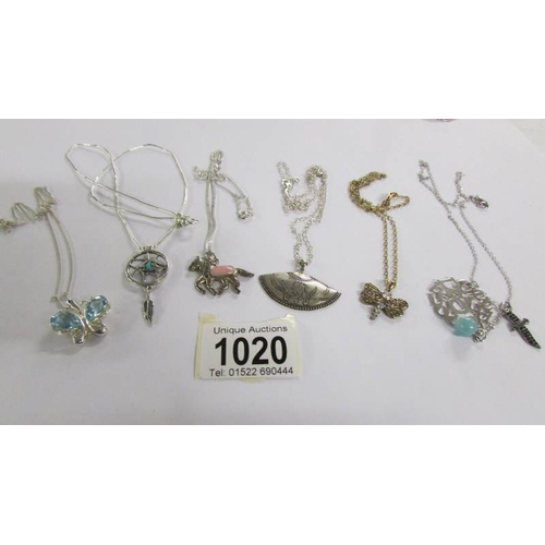 1020 - 5 assorted silver pendants and one other.