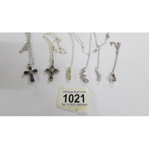 1021 - 6 assorted silver pendants.