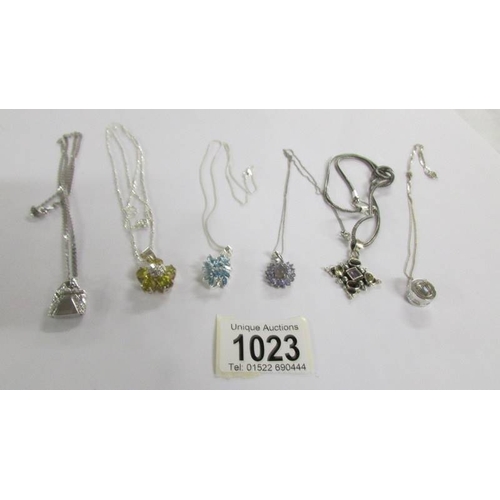 1023 - 6 assorted silver pendants.