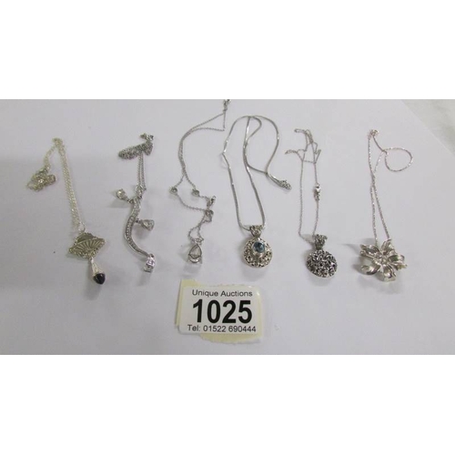 1025 - 6 assorted silver pendants.