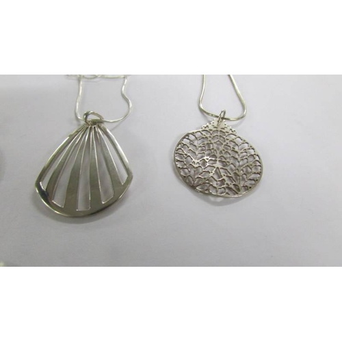 1026 - 4 assorted silver pendants.