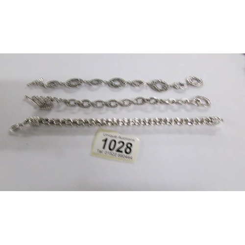 1028 - Three silver bracelets.