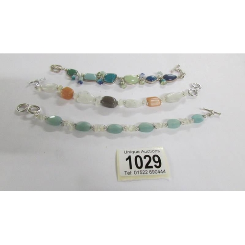 1029 - Three silver and coloured stone bracelets.