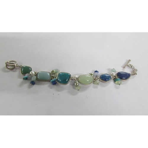 1029 - Three silver and coloured stone bracelets.