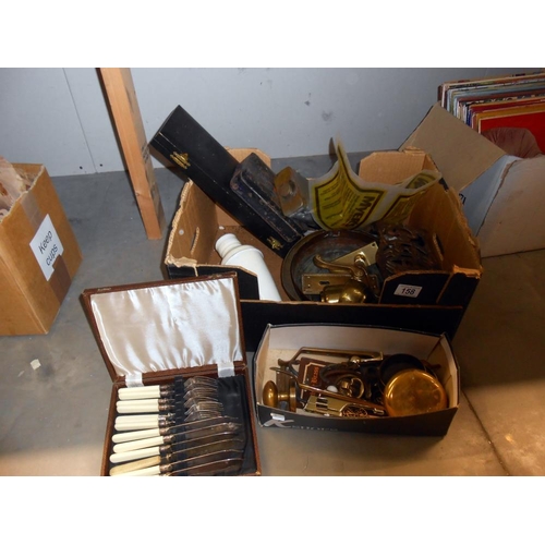 158 - A box of assorted brassware, including boxed set of fish knives and forks, trivet, old tin, door fur... 