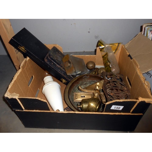 158 - A box of assorted brassware, including boxed set of fish knives and forks, trivet, old tin, door fur... 