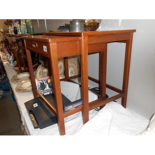 189 - A teak 2 piece nest of tables, small table has a drawer