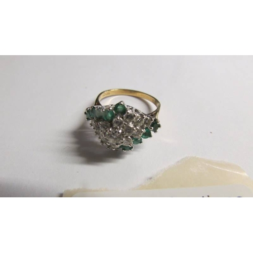 2003 - An 18ct gold diamond and emerald ring, size P.