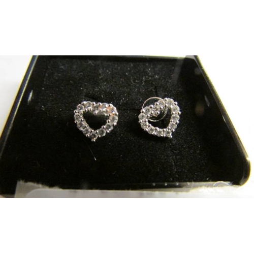 2013 - A pair of 18ct white gold heart shaped half carat total diamond earings.