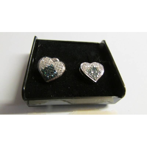 2014 - White and blue diamonds set in white gold earrings.