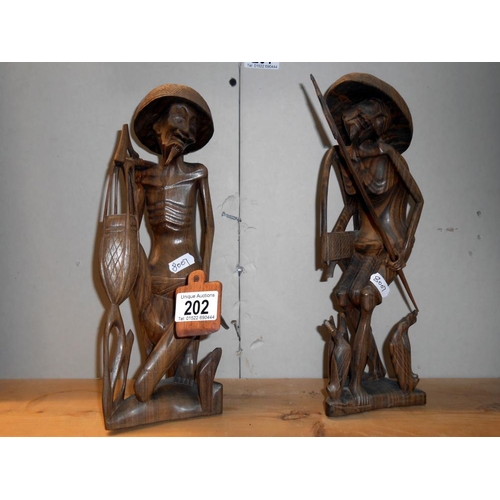 202 - 2 carved wooden oriental figures