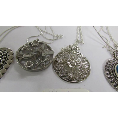 2026 - 6 assorted silver pendants.