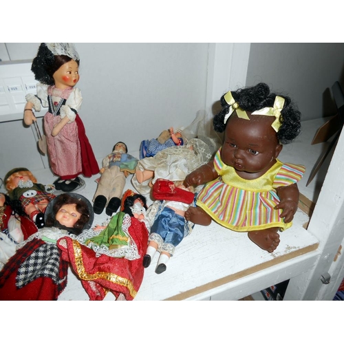 243 - A large quantity of vintage costume dolls etc. in as found condition