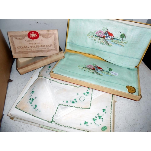 258 - A box of vintage textiles including embroidered household linens. mats & handkerchiefs