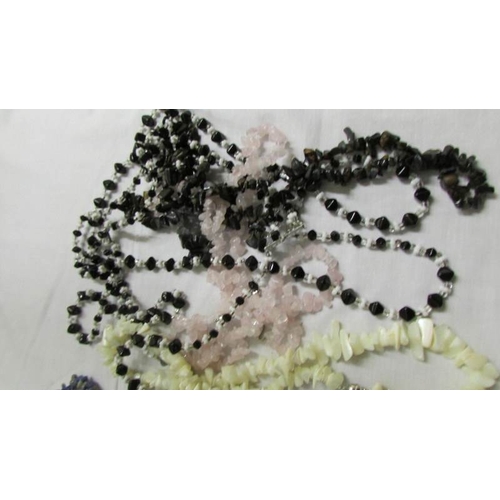 1037 - A mixed lot of assorted chip necklaces and bracelets,.