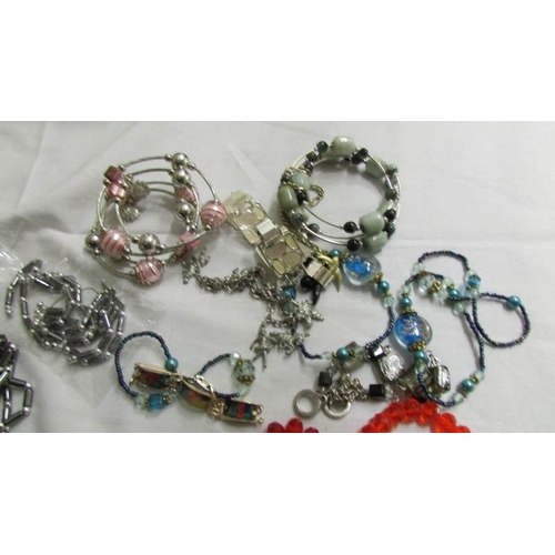 1038 - A grey necklace, bracelet and earrings, a similar set in black and six assorted bangles and bracelet... 