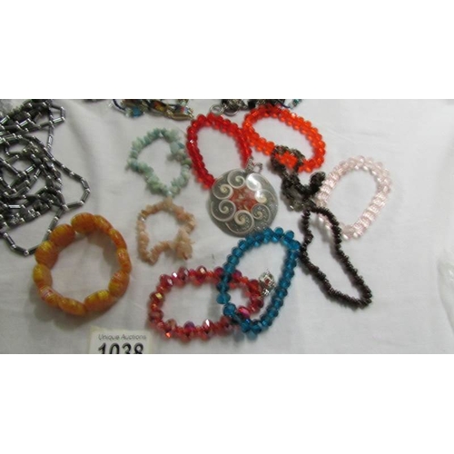 1038 - A grey necklace, bracelet and earrings, a similar set in black and six assorted bangles and bracelet... 