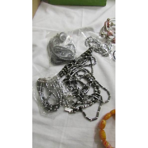 1038 - A grey necklace, bracelet and earrings, a similar set in black and six assorted bangles and bracelet... 