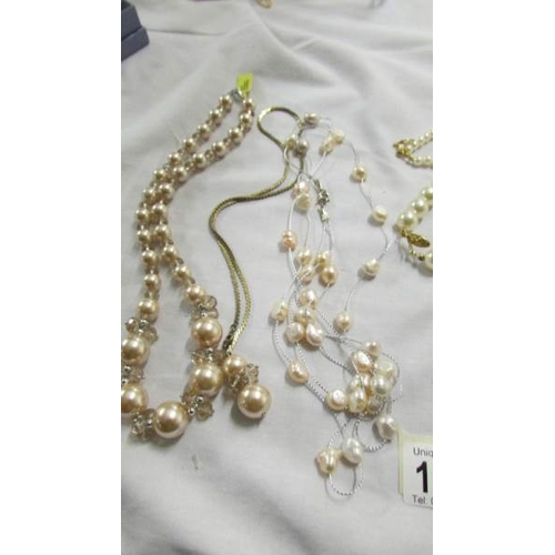 1055 - A quantity of 'pearl' necklaces and bracelets.