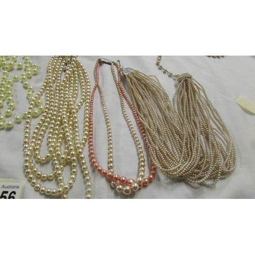 1056 - A mixed lot of pearl and other necklaces.