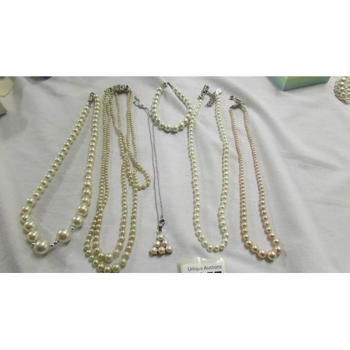 1057 - Four 'pearl' necklaces, pendant and bracelet.