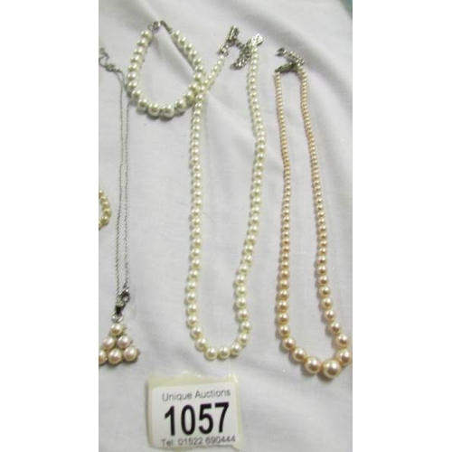 1057 - Four 'pearl' necklaces, pendant and bracelet.