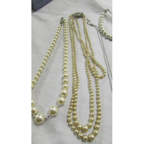 1057 - Four 'pearl' necklaces, pendant and bracelet.