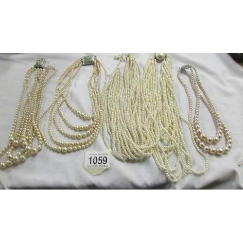 1059 - Five multi strand 'pearl' necklaces,