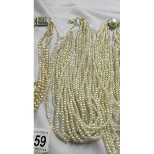 1059 - Five multi strand 'pearl' necklaces,