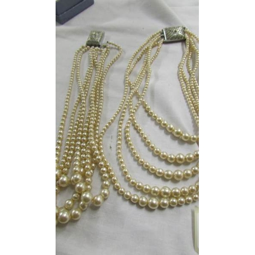 1059 - Five multi strand 'pearl' necklaces,