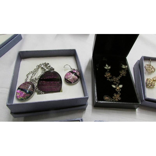 1062 - Five assorted pendants with matching earrings and four other pendants.