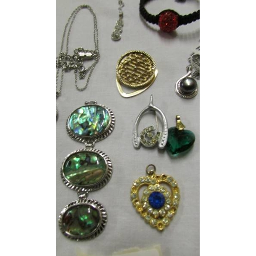 1063 - A mixed lot of pendants, chains etc.,