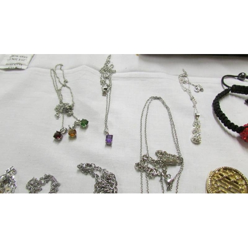 1063 - A mixed lot of pendants, chains etc.,