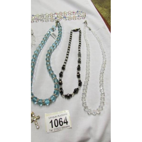 1064 - 7 crystal necklaces and 2 pendants.