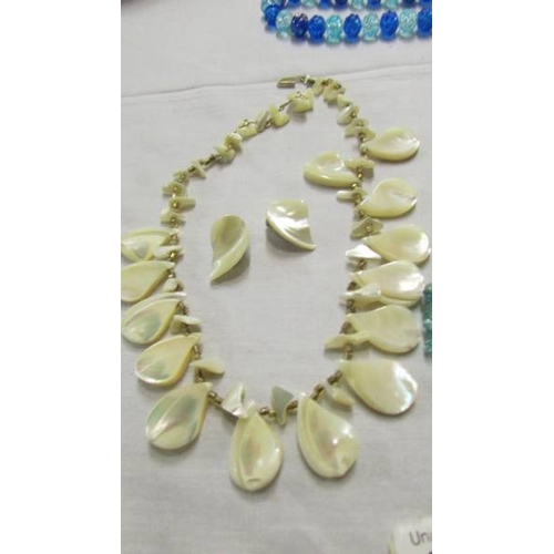 1069 - 3 colourful necklaces and a mother of pearl necklace with clip on earrings.