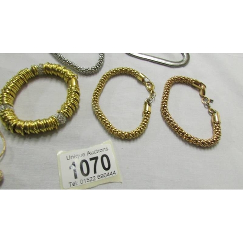 1070 - 3 gold coloured bracelets, 2 silver coloured bracelets and a gold coloured pendant.