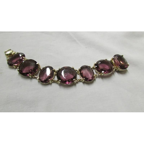 1071 - A good quality necklace and bracelet with amethyst coloured stones and a bracelet with blue stones.