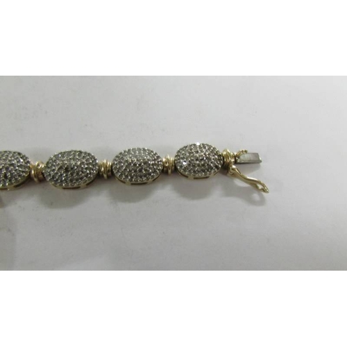 2059 - A 9ct gold and diamond bracelet (missing some diamonds).